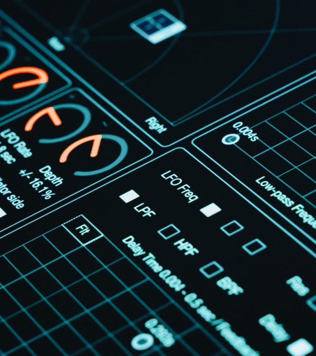 Close-up of a digital interface showcasing futuristic graphs and data analytics in low light.